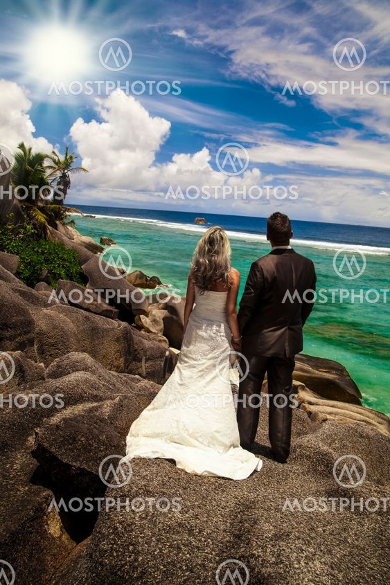 Bride and groom looking out over the ocean