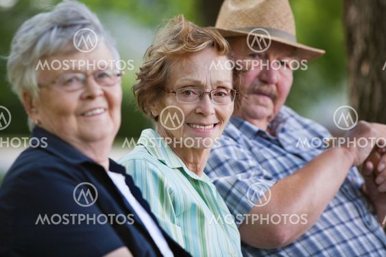 Senior friends sitting together in park