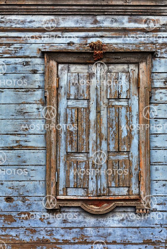 Window with closed shutters on an old building.