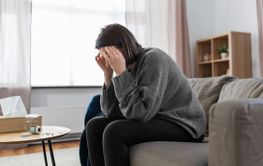 stressed woman with medicine having headache