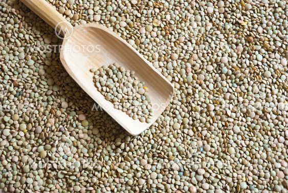 Raw lentil with wooden scooper