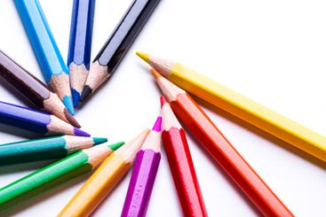 Colorful assortment of colored pencils arranged in a...
