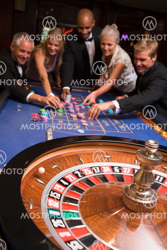 Group of friends gambling in casino