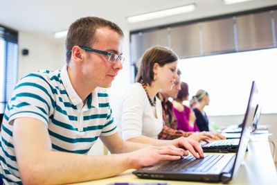 Group of college/university students in in a classroom...