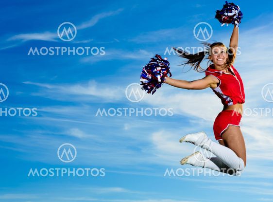 Young cheerleader in red costume jumping