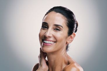 Portrait, smile and skincare with woman in studio for...