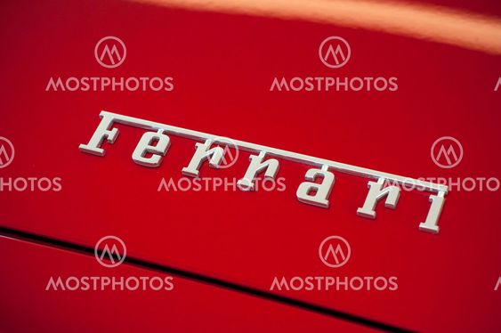 Ferrari brand sign on red sport car in ferrari retailer...