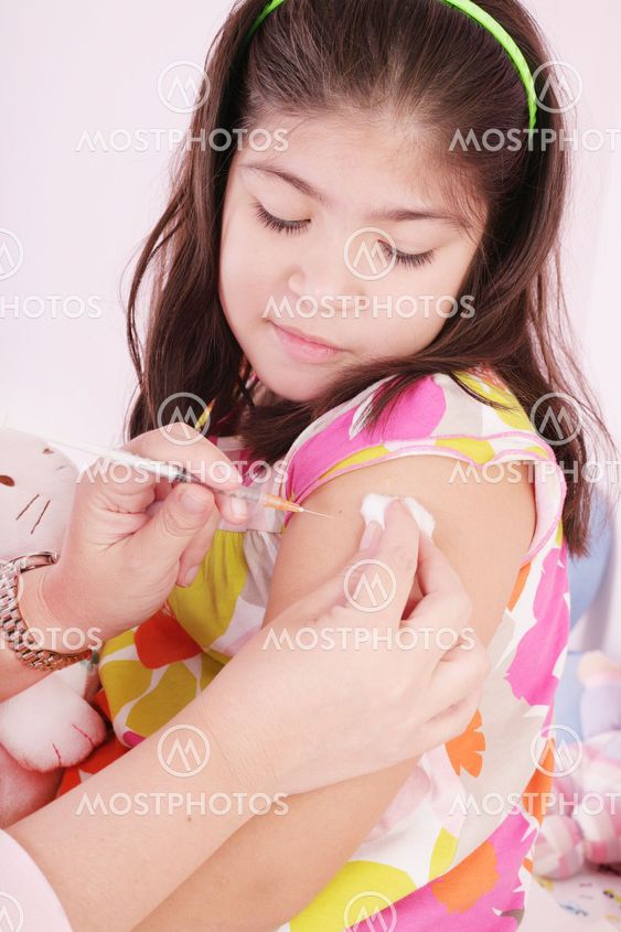 child receiving an injection by the hands of a pediatrician