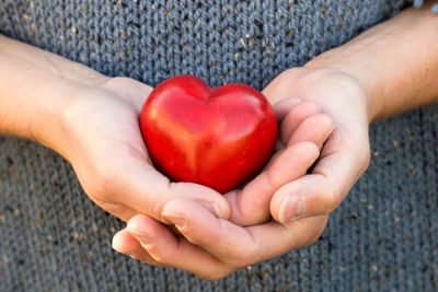 woman showing red heart of love