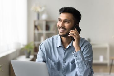 Smiling confident male make answer telephone call...