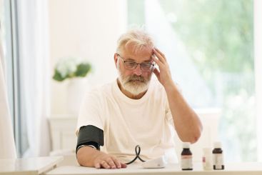 Senior man measuring blood pressure