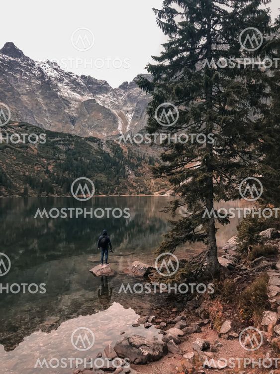 a man stands on the Big Stone in the middle of lake...