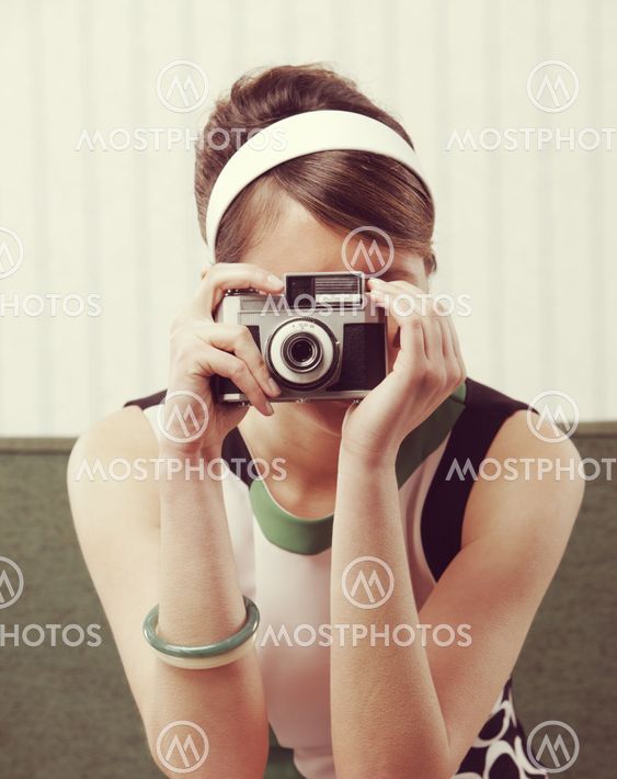 Retro woman with old-fashioned camera
