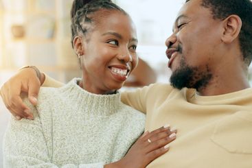 Care, relax or happy black couple hug on home living...