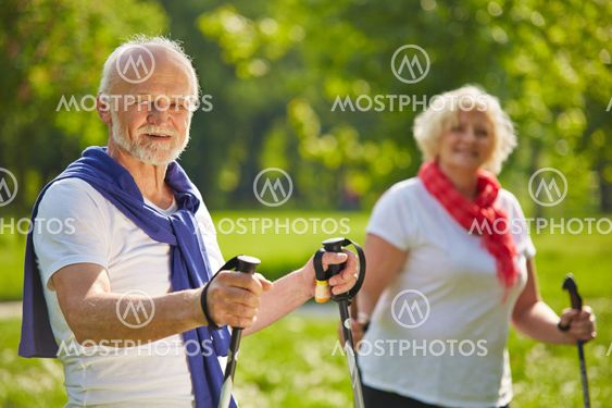 Senior couple hiking together in summer
