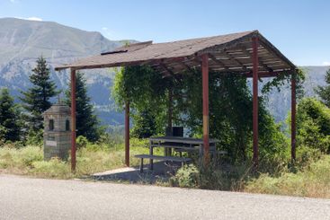 Wooden gazebo in the mountains near the mountain road...