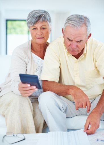 Mature couple calculating domestic budget. Mature couple...