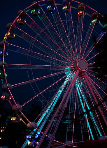 A colourful ferris wheel in Luna park during night.