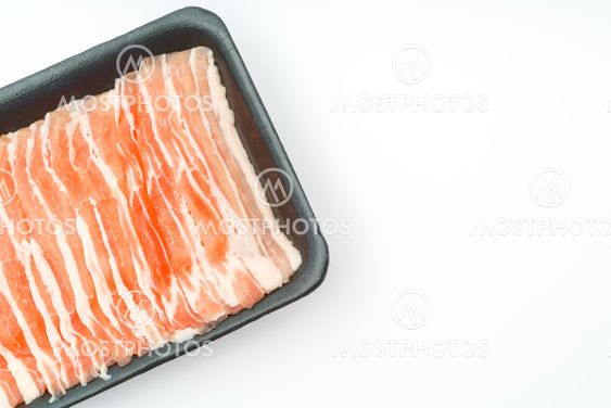 Slide of raw pork on white background .