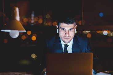 Concentrated Business Guy At Laptop Working Wearing...