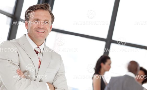 Smiling confident male manager leading his team