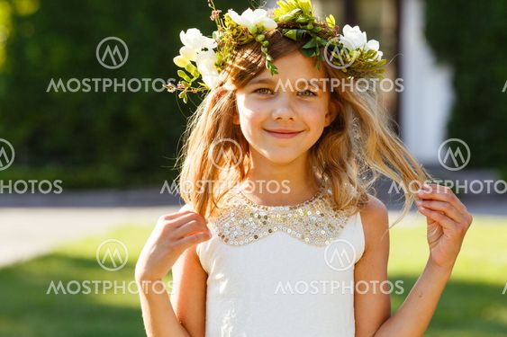 Beautiful girl with a wreath of fresh flowers
