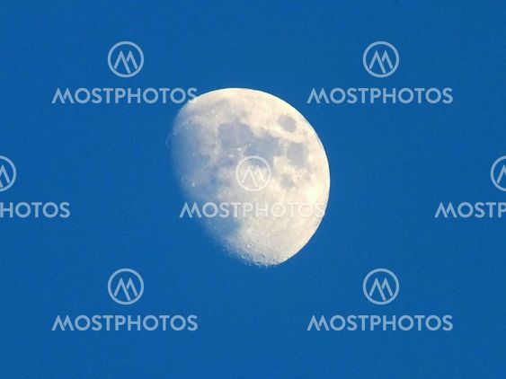 True full moon against a blue sky.