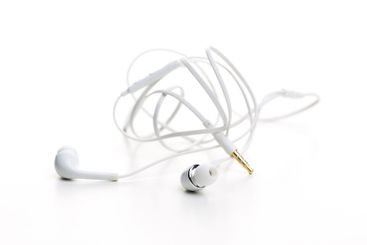 Pair of earphones close up on grey background