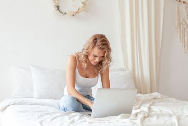 Young woman using her laptop at home