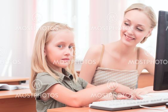 teacher sitting near pupil