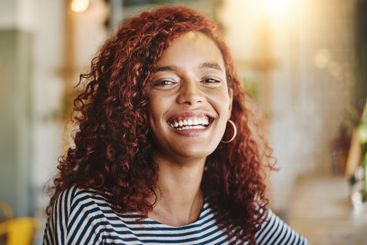 Happy woman, portrait or laughing with joy at cafe for...