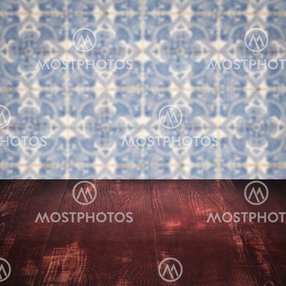 Wood table top and blur vintage ceramic tile pattern wall