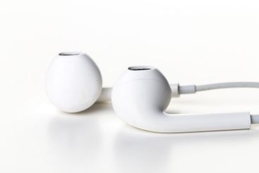 Pair of earphones close up on grey background