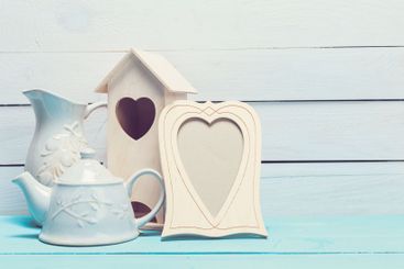 Cozy pastel wooden home decor objects on blue background