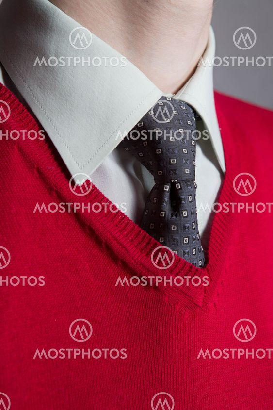 Man wearing white shirt, red sweater and necktie
