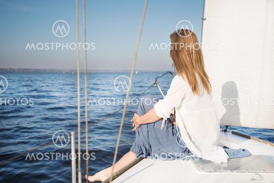 woman sitting on sailboat