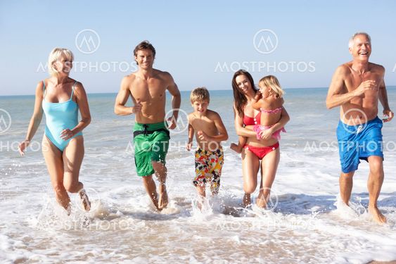 Three generation family play on beach