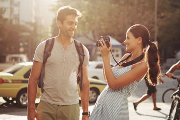 Couple, tourism and photography in street for travel,...