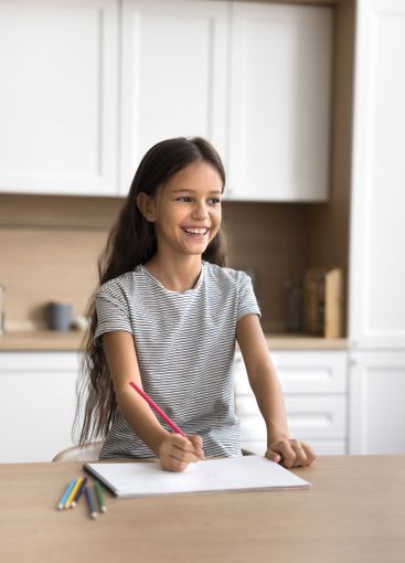 Adorable small girl spend time for painting at domestic...