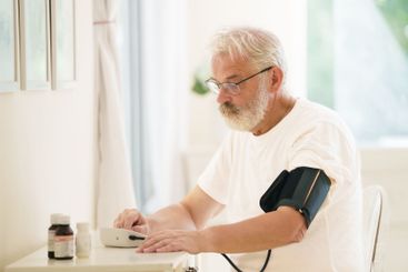 Senior man measuring blood pressure