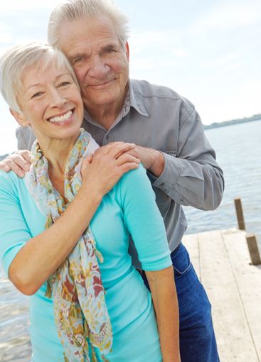 Portrait, holiday and senior couple at lake for travel,...