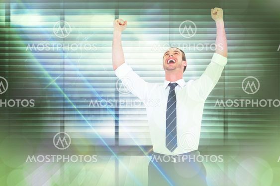 Composite image of handsome businessman cheering with arms up