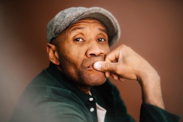 Contemplative mature man with beret in studio
