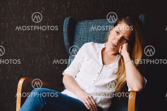 Young woman sitting alone and waiting