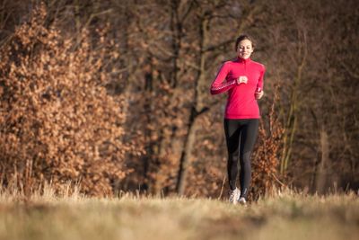 Young woman running outdoors on a lovely sunny...