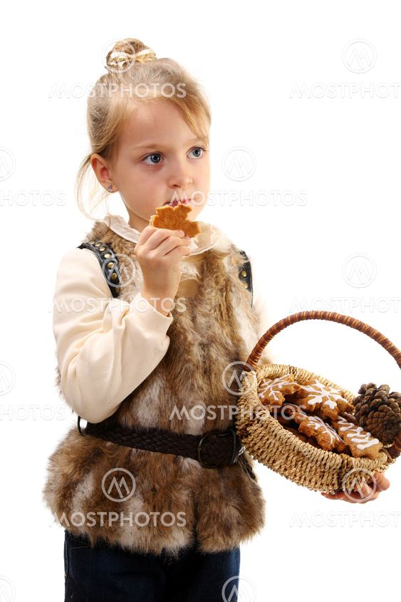 Little girl with a basket and Christmas cookies.