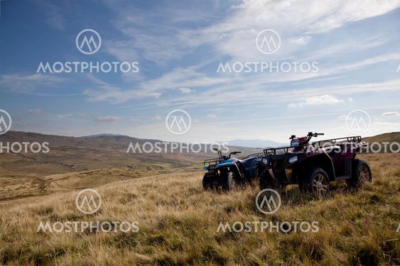 Pair of ATV quad bikes on lonely mountain