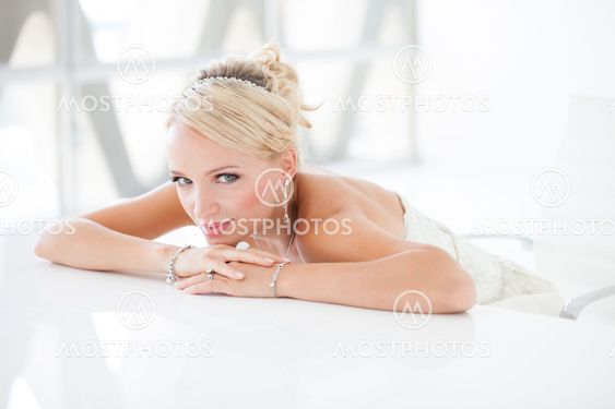 Beautiful blond bride sitting at a table