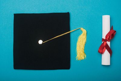 Top view of black graduation cap with yellow tassel and...