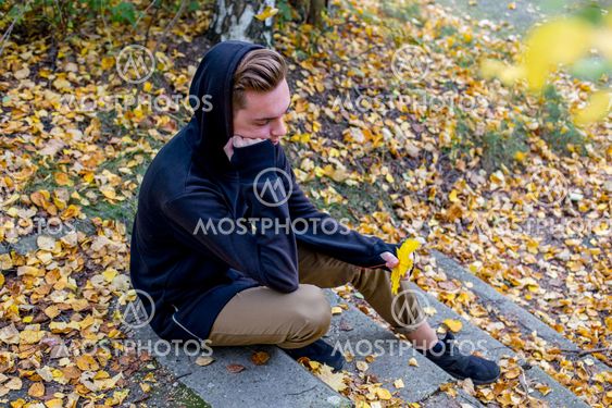 Depressed guy walking in park